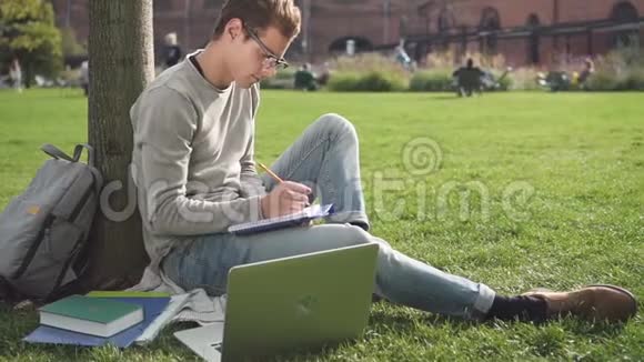 美国男人看电脑屏幕写作坐在大学里视频的预览图