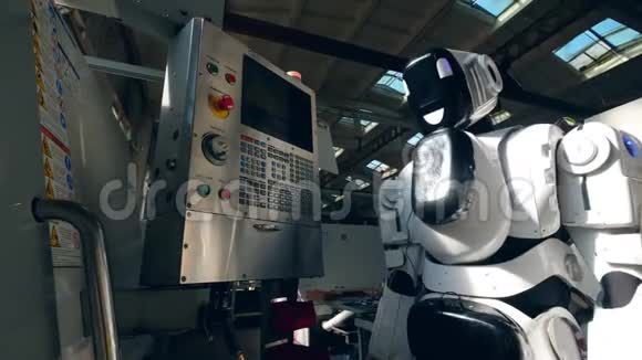 高大的机器人正在按下控制面板上的按钮视频的预览图