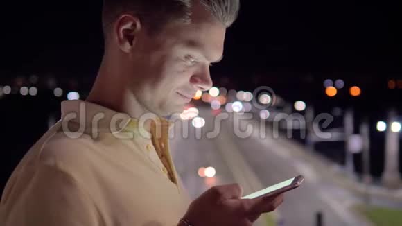 白种人晚上用智能手机发短信视频的预览图