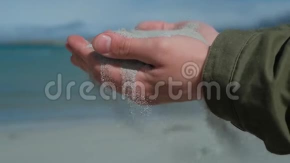 人手中的沙子近距离观察沙子穿过一个人的手从手中掉落的沙子视频的预览图