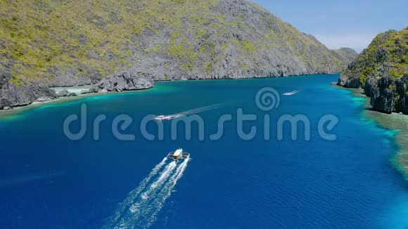 Drone在菲律宾巴拉望的ElNido马蒂诺克岛和塔皮图坦岛之间的海峡中跟随岛屿跳跃船视频的预览图