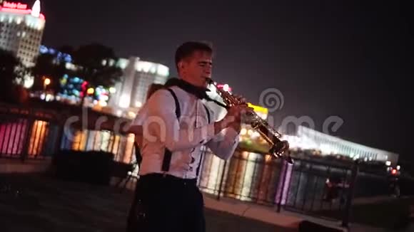 街头音乐家在大城市的夜间长廊上的伟大表演视频的预览图