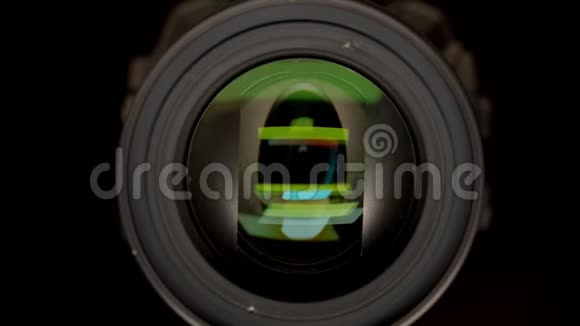 特写镜头的目标是视频摄像机与绿色反射在它孤立的黑色视频的预览图