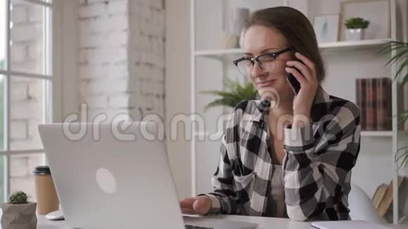美国企业主女商人在持票人电话上交谈看着家里的显示器视频的预览图