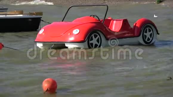 海浪中汽车形状的塑料红船视频的预览图
