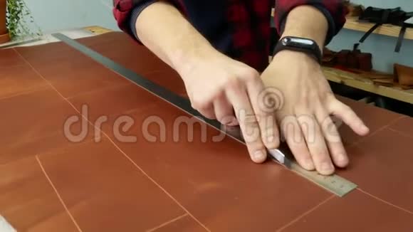 工匠用办公刀把半张真皮切成一张手工制造的手持视频的预览图
