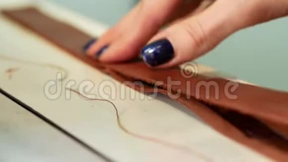 女工人涂两层皮在一家服装厂手工皮革制品手工制作视频的预览图