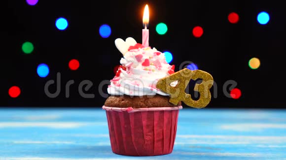 带有蜡烛的美味生日蛋糕和43号的彩色模糊灯光背景视频的预览图