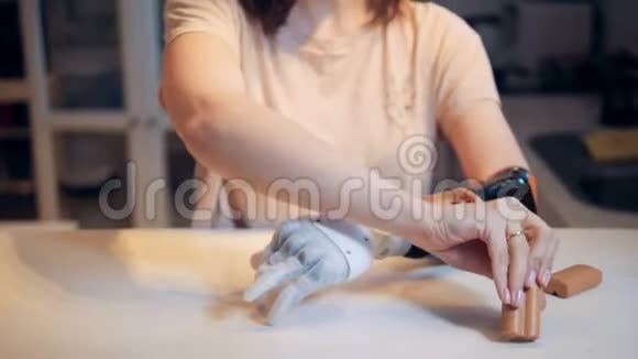 一名妇女正在将电池插入假手视频的预览图