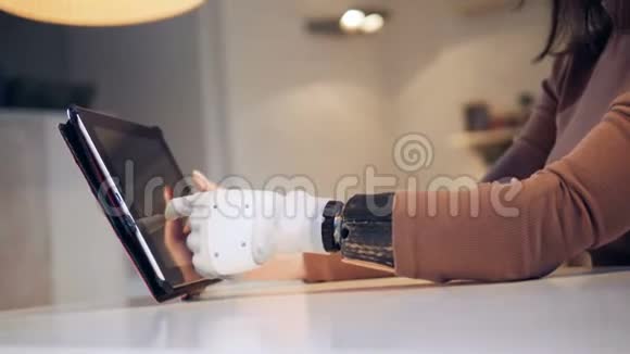 平板电脑是由一只有仿生手臂的女性操作的视频的预览图