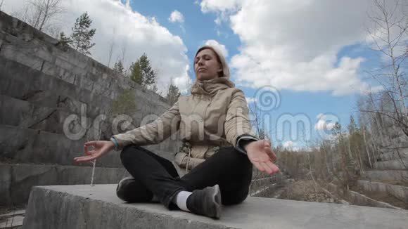 女人在冥想大理石废弃大理石矿床视频的预览图