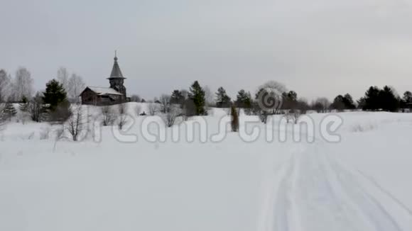 雪上汽车司机穿过雪谷来到古老的教堂视频的预览图