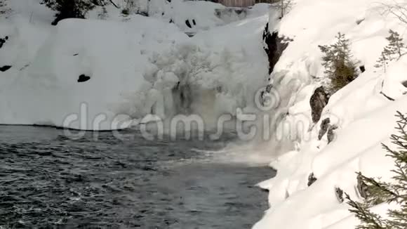 瀑布落入被雪岸包围的小海湾视频的预览图