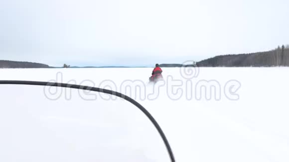 雪上摩托司机穿过快速宽阔的白雪高地视频的预览图