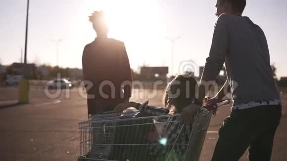 年轻的朋友在购物车上玩得很开心多种族的年轻人玩购物车男性朋友的立场视频的预览图