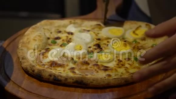 慢动作厨师在意大利餐厅厨房切一块美味的披萨视频的预览图