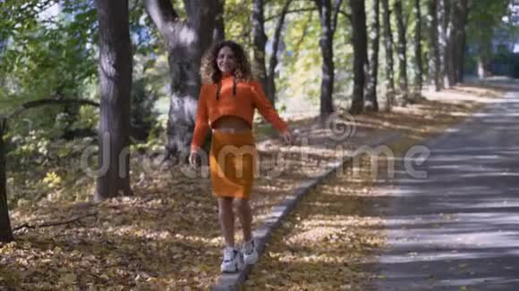 Energichnaya少女走在路边开朗的卷曲女孩笑更长的镜头4k视频的预览图