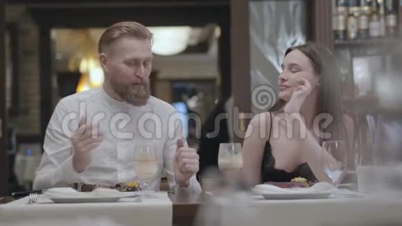 一对美丽的年轻夫妇在咖啡馆或餐馆吃饭的肖像在咖啡馆里放松的时候伙伴们会交流这就是视频的预览图