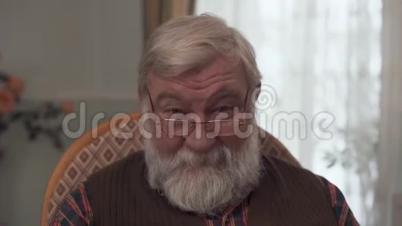 一幅成年可爱的祖父留着大胡子鼻子上戴着矫正眼镜的样子视频的预览图