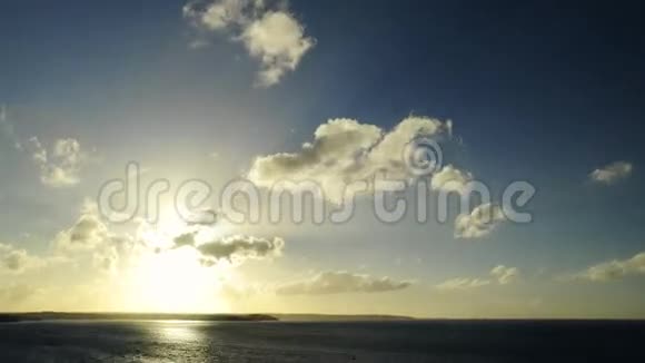 远处海面和地平线上的悬崖上的日落的宽镜头在悬崖上逐渐放大视频的预览图
