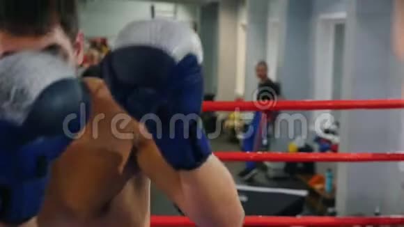 拳击两个挥汗如雨的男人在体育馆里激烈地打架视频的预览图