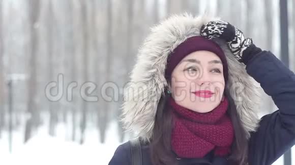美丽的年轻女孩在雪地公园里喝杯咖啡享受冬天的气氛视频的预览图