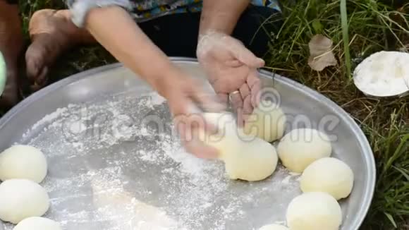妇女用托盘制作面包的手工面团的特写镜头视频的预览图