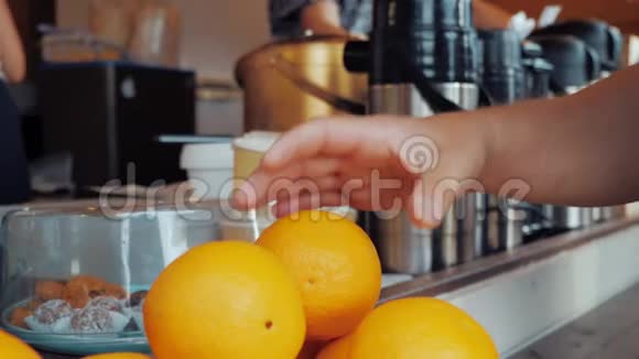 一个人从咖啡馆柜台拿了一个橘子扔到空中视频的预览图