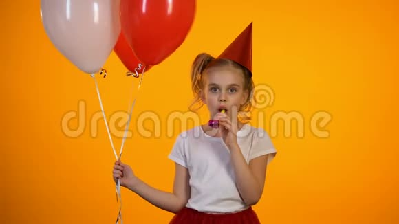 可爱的女孩带着派对鼓风机拿着气球庆祝生日快乐视频的预览图