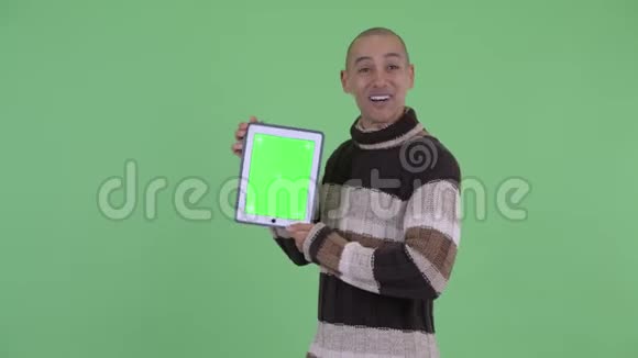 快乐的秃头多民族男子显示数字平板电脑看上去惊讶视频的预览图