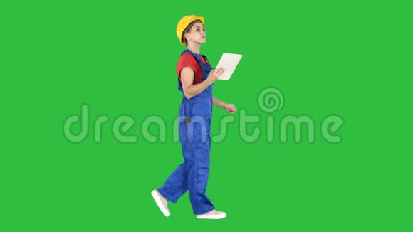 施工女士使用电子平板行走在绿色屏幕上色度键视频的预览图