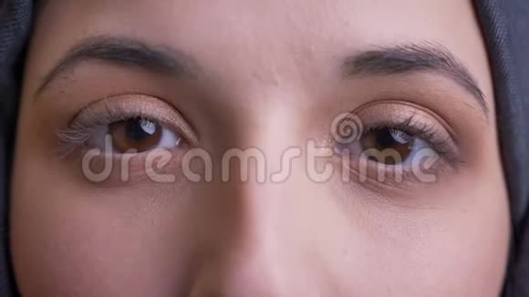 特写巨幅照片年轻美丽的阿拉伯女性棕色眼睛眨着眼睛用相机直视视频的预览图