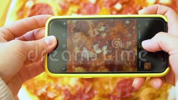 在黄色封面的智能手机上拍披萨视频的预览图