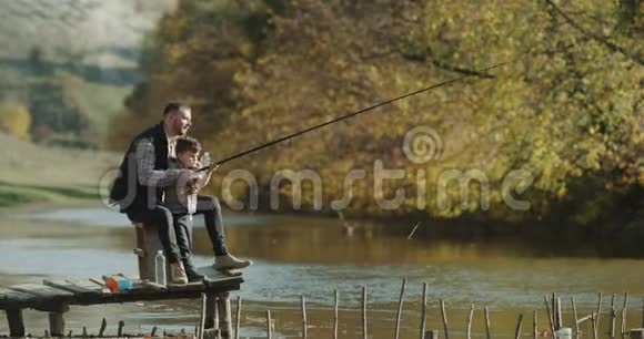 爸爸教儿子如何从湖里钓鱼视频的预览图