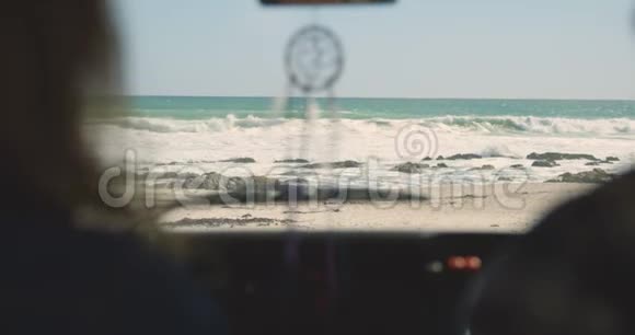 女性的后视图手指显示海浪对男子在汽车4k视频的预览图