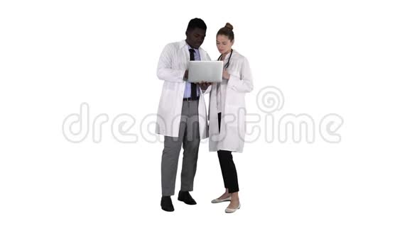 医务人员站在白色背景下在灰色笔记本电脑前工作视频的预览图