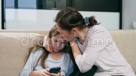 妈妈抚慰了女儿一个泪流满面的女孩坐在她母亲腿上视频的预览图