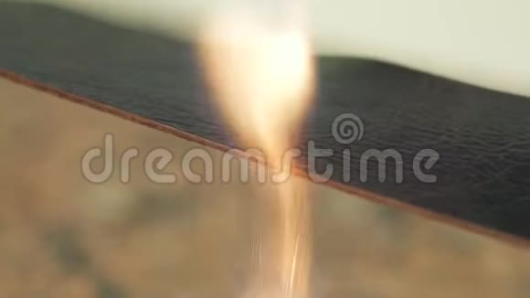 男人用手在火上加工皮革制成皮带视频的预览图