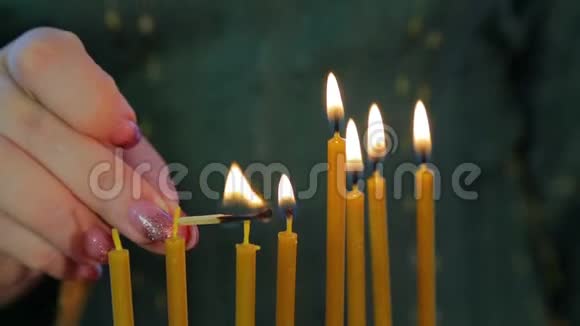 一只雌性手在光明节上用漂亮的烛台点燃蜡烛视频的预览图