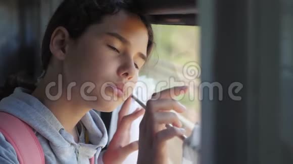 悲伤的女孩望着火车窗外旅游运输铁路概念少女怀念生活方式的旅行视频的预览图