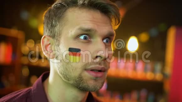 快乐的德国足球迷脸上挂着旗子为球队进球感到高兴赢得了胜利视频的预览图