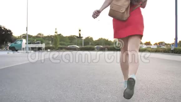 在城市大街上走着的一位卷发美女的后景然后她转向镜头视频的预览图