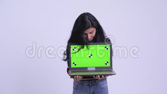 快乐的年轻美丽的波斯女人说话展示笔记本电脑视频的预览图