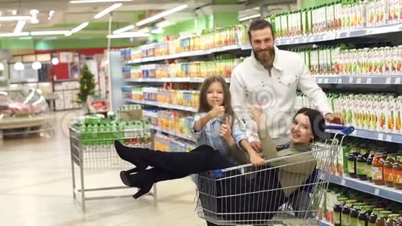 超市里快乐家庭的画像妈妈坐在购物车里视频的预览图