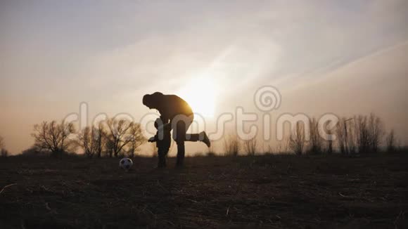 在日落时分孩子们在草地上踢足球友好家庭观念视频的预览图