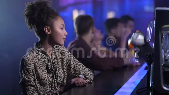 一个独身的美女坐在夜总会的酒吧里视频的预览图