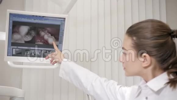 牙医给病人看x光肖像迷人美丽的女孩医生牙医在牙科诊所医药视频的预览图