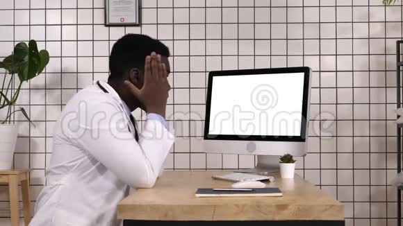 震惊的医生看着电脑屏幕白色显示器视频的预览图