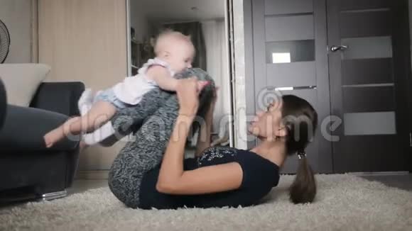 妈妈带着可爱的宝宝在家做体操视频的预览图