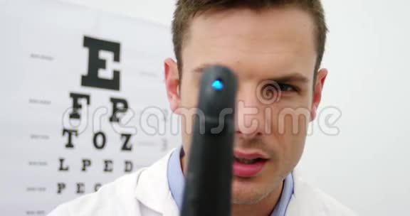 验光师通过检眼镜检查的特写视频的预览图